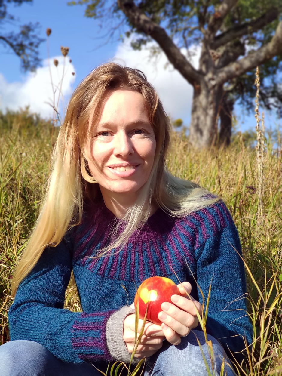 Maike Hanneck auf einer Streuobstwiese mit einem Apfel in der Hand